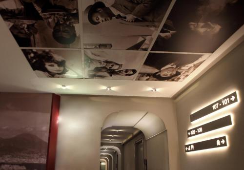 a hallway with a ceiling with pictures on it at Partenope Relais in Naples