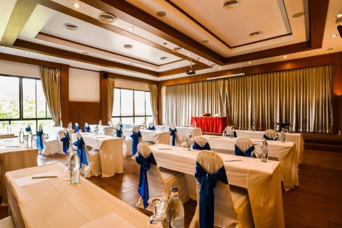 a banquet hall with white tables and chairs at Ramada by Wyndham Aonang Krabi in Ao Nang Beach