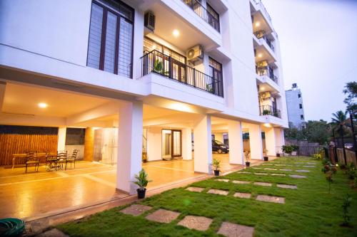 a large white building with a lawn in front of it at Stay@ in Bangalore