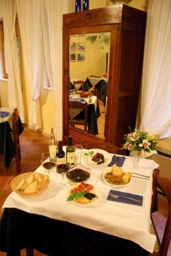 a table with plates of food and a mirror at Hotel Relais Valle Orientina in Pitigliano