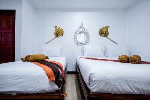 A bed or beds in a room at Chedi Home -SHA Extra Plus