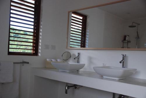 a bathroom with two sinks and a mirror at Villa Noria in Las Terrenas