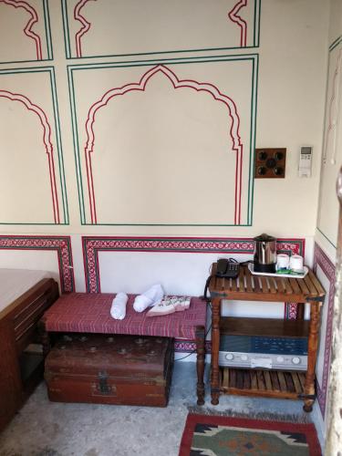a small room with a bench and a table at Jaipur Haveli in Jaipur