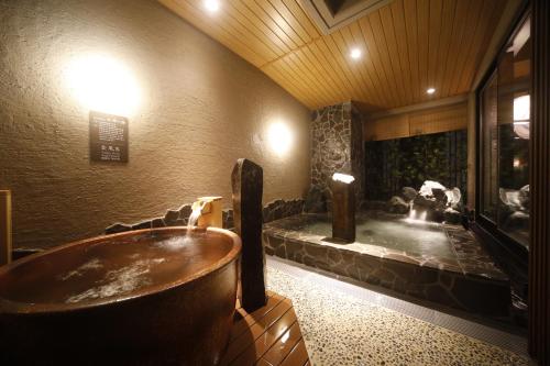 a bath tub in a room with a fountain at Dormy Inn Premium Osaka Kitahama in Osaka