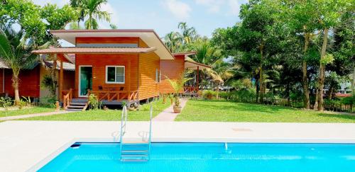 a house with a swimming pool in front of a house at Jungle View Resort in Ko Chang