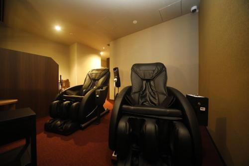 two black chairs sitting in a waiting room at Dormy Inn Premium Osaka Kitahama in Osaka