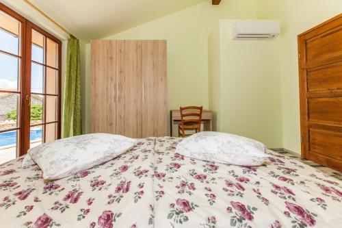 a bedroom with a bed with two pillows and a window at Villa Nabucco in Kras