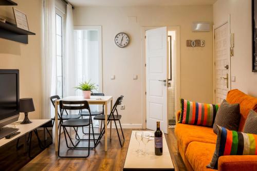 a living room with a couch and a table at Barbieri in Madrid