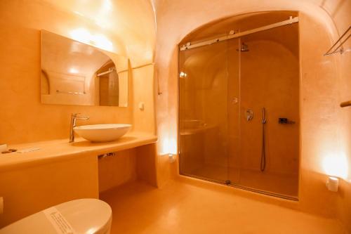 a bathroom with a shower and a sink at Ilioperato Hotel in Imerovigli