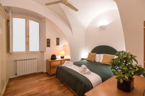 a bedroom with a green bed and a window at Lovely New Home, Via Nazionale in Rome