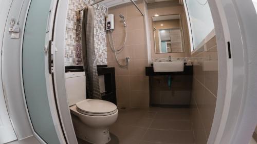 a bathroom with a toilet and a sink at Step One at Bangkok in Bangkok