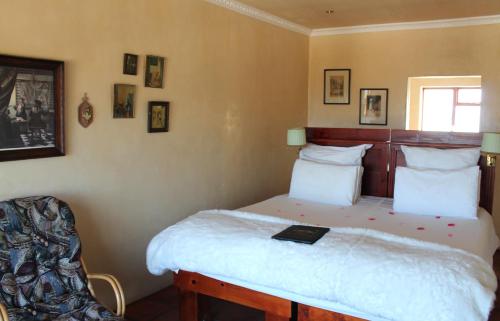 a bedroom with a bed with a book on it at Goblin's Inn in Stompneusbaai