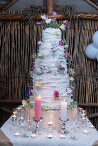 a white wedding cake with candles on a table at Old Halidzor in Halidzor