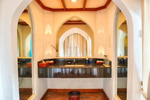 a bathroom with a sink and a mirror at Jetwing Lighthouse, A Luxury Reserve in Galle