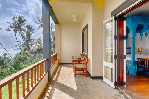 a balcony with a view of the ocean at Jetwing Lighthouse, A Luxury Reserve in Galle