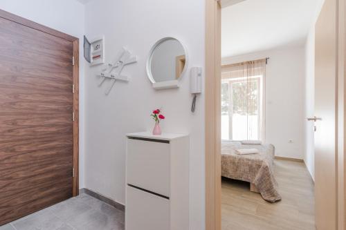a small room with a mirror and a bed at Pasko 4 modern furnished ap for 7 in Novalja