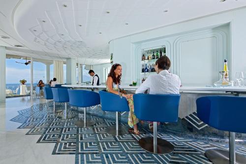 two women sitting at a bar in a hotel at Grand Hotel Riviera in Sorrento
