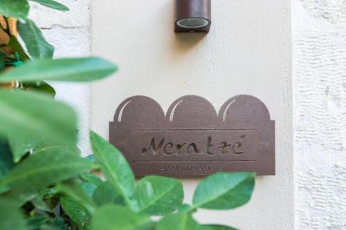 a sign on the side of a wall at Neratze Hammam Suites in Rethymno Town
