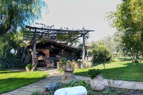 a garden with a pavilion in a park at Casa Zafferano in Albenga