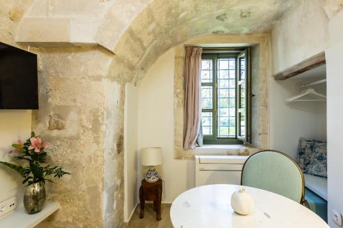 a dining room with a table and a window at Neratze Hammam Suites in Rethymno Town