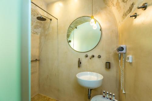 a bathroom with a sink and a mirror at Neratze Hammam Suites in Rethymno Town