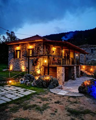 a stone house with lights in front of it at Green's House in Poliána