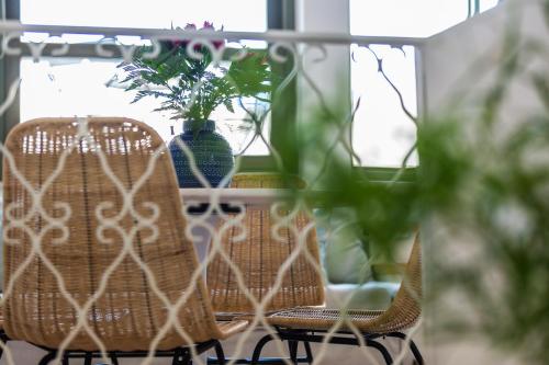 a table with two chairs and a vase with plants at Neratze Hammam Suites in Rethymno Town