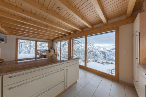 a kitchen with a view of the mountains at Chalet Nid Blanc in Nendaz