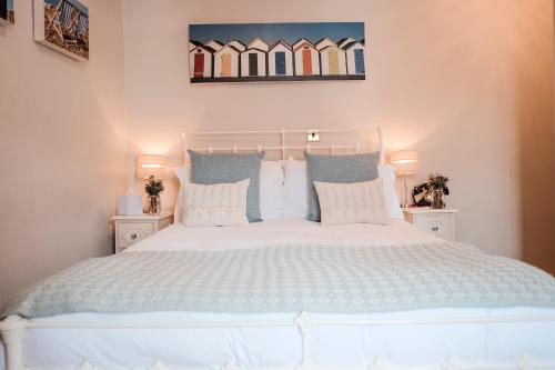 a white bed with a white comforter on top of it at Swan Hotel in Arundel