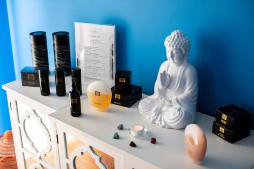 a white statue sitting on a shelf with some items at Pousada de Sagres in Sagres