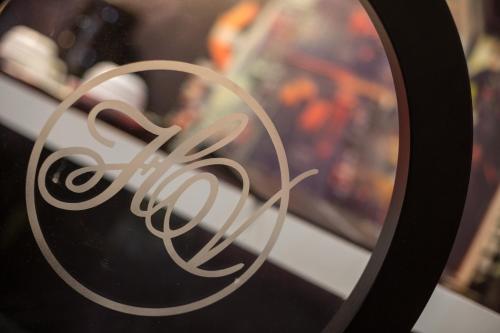 a close up of a white sign in a mirror at Hôtel Les Voyageurs in Bastia