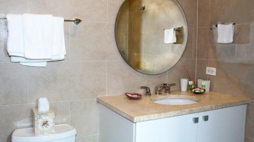 a bathroom with a sink and a mirror at Villa Athena in Rio Grande