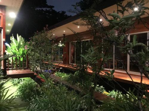 a house with a lot of plants in front of it at 88 Homestay in Bang Chak