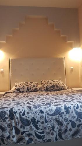 a bed with two pillows on top of it at Bonito Apto Cinco Torres Plaza Castilla in Madrid