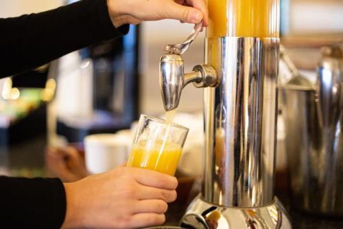 a person is pouring a drink into a blender at The Imperial Torquay in Torquay