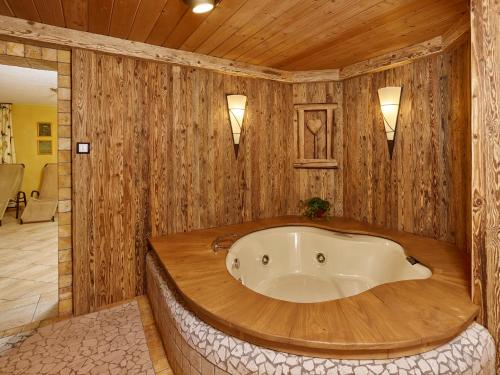 a bath tub in a room with wooden walls at Apparthof Sunnwies in Oetz