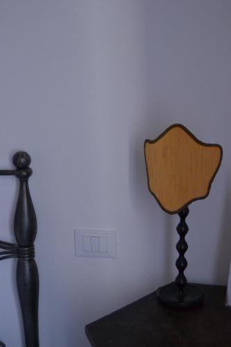 a lamp sitting on a table next to a wall at Time Out in Pisa