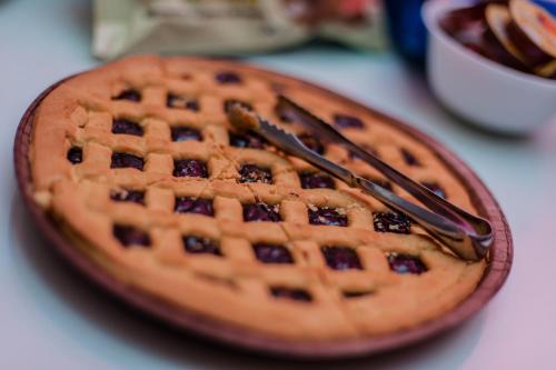 a waffle sitting on a plate with two utensils at Rodizio Hill Resort in Cluj-Napoca