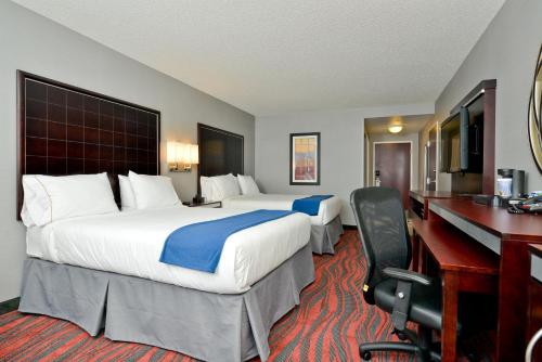 a hotel room with two beds and a desk at Holiday Inn Express Canandaigua by IHG in Canandaigua