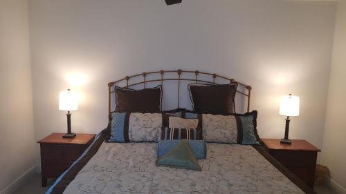 a bedroom with a large bed with two lamps at Beautiful Condo Close to Busch Gardens in Tampa