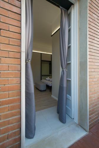 a door with curtains open to a bedroom at Destil B&B in Tirana