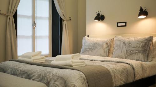 a bedroom with a bed with towels on it at Destil B&B in Tirana