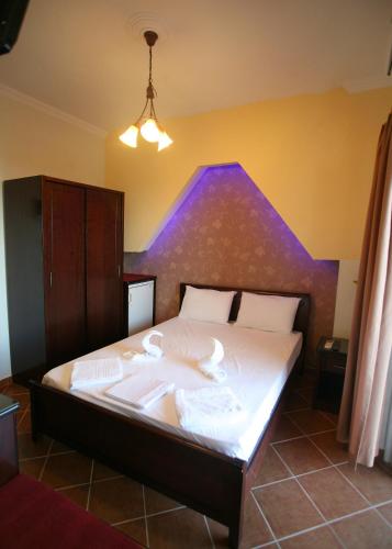 a bed with two swans on it in a room at Elena Rista Studios in Parga
