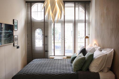 a bedroom with a bed in front of a window at Villa360 in Amsterdam