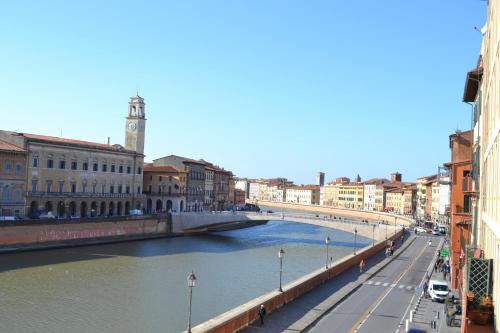 a bridge over a river in a city at You & Me in Pisa