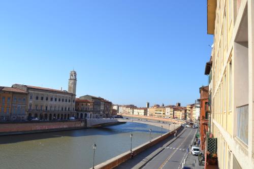 a bridge over a river in a city at You & Me in Pisa