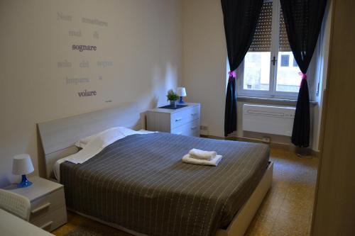 a bedroom with a bed with two towels on it at You & Me in Pisa