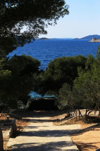 a path with trees and a large body of water at Mobile homes-Slanica in Murter