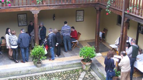 people standing outside of a building at Castillo De Valdés Salas in Salas