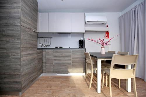a kitchen with a table and chairs in a room at Mobile homes-Slanica in Murter